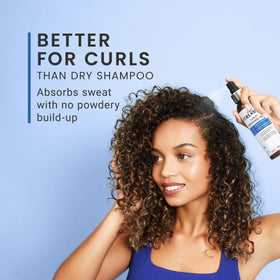 CURLSMITH bottle in hand to show CurlFit compact travel size
