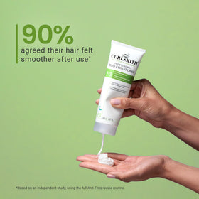 CURLSMITH cream smoothed on a hair strand showing detangling benefit