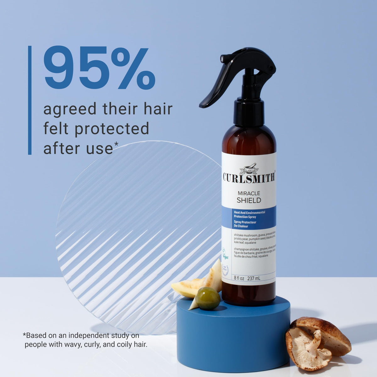 CURLSMITH spraying on damp curls for heat and environmental protection