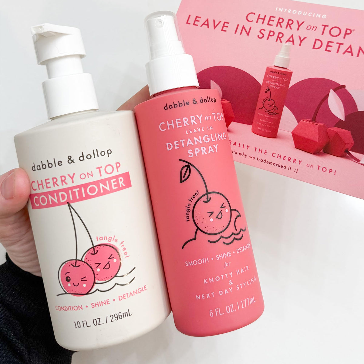 Dabble & Dollop bottles in hand showing Cherry on Top size and portability