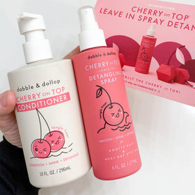 Dabble & Dollop bottles in hand showing Cherry on Top size and portability