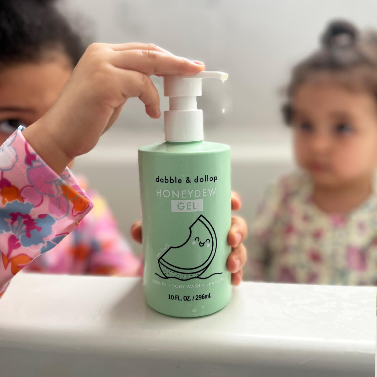 Dabble & Dollop bottle next to a toy demonstrating 10 fl oz scale