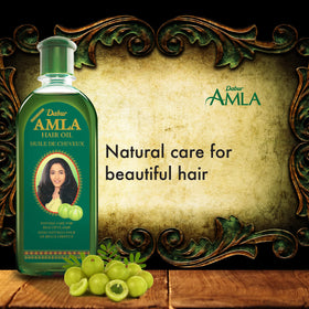 Dabur oil on hands during application demonstrating easy spread and nourishment