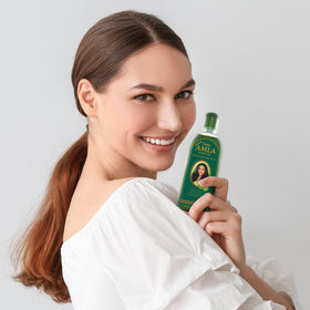 Dabur bottles on bathroom shelf in lifestyle setting suggesting daily use benefit