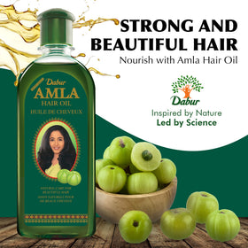 Dabur oil poured to show smooth texture and easy application benefit