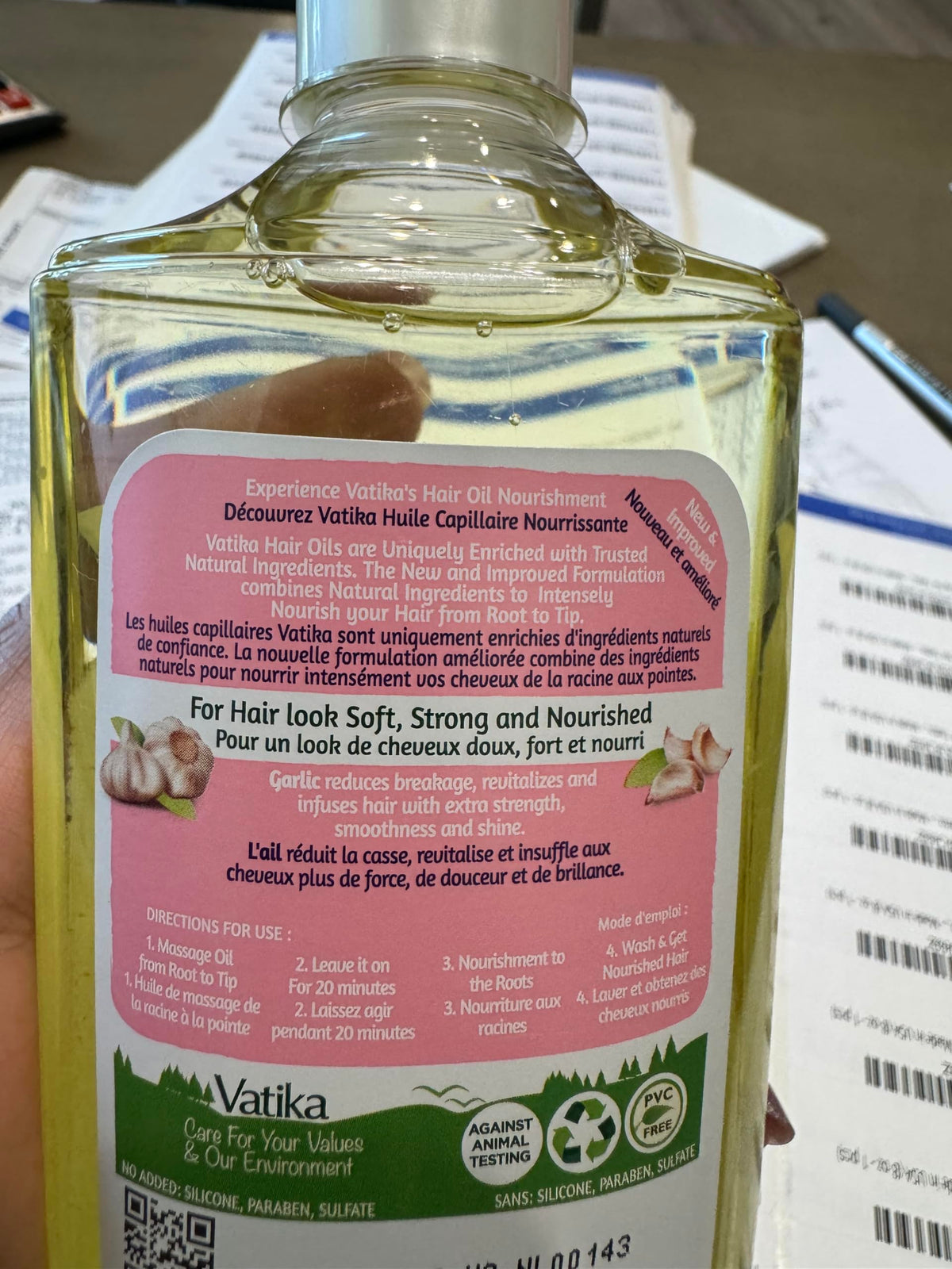 Close-up of Dabur Vatika oil pour showing smooth texture for easy application