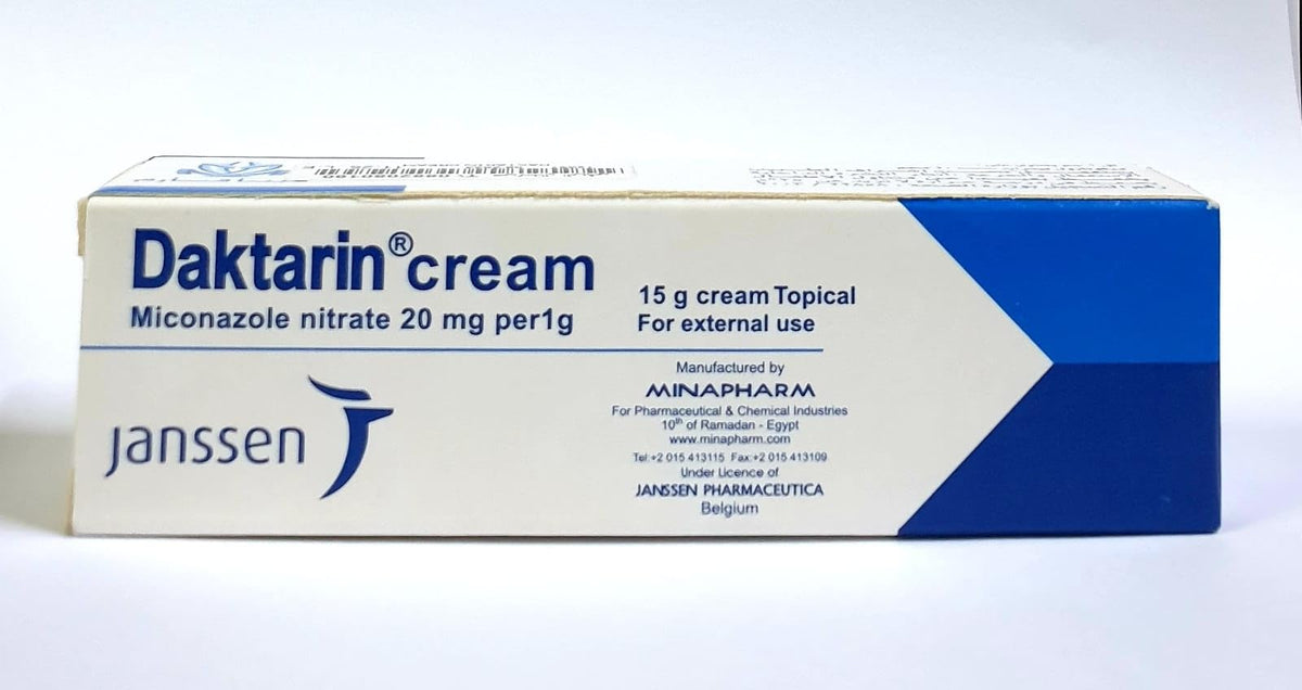 Daktarin cream texture on fingertip demonstrating smooth spreadability and quick absorption
