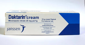 Daktarin cream texture on fingertip demonstrating smooth spreadability and quick absorption