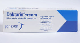 Daktarin next to a coin to show 15g tube size and portability for travel convenience