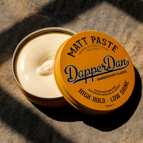 Dapper Dan size scale with 100ml jar beside a comb, shows travel-friendly volume