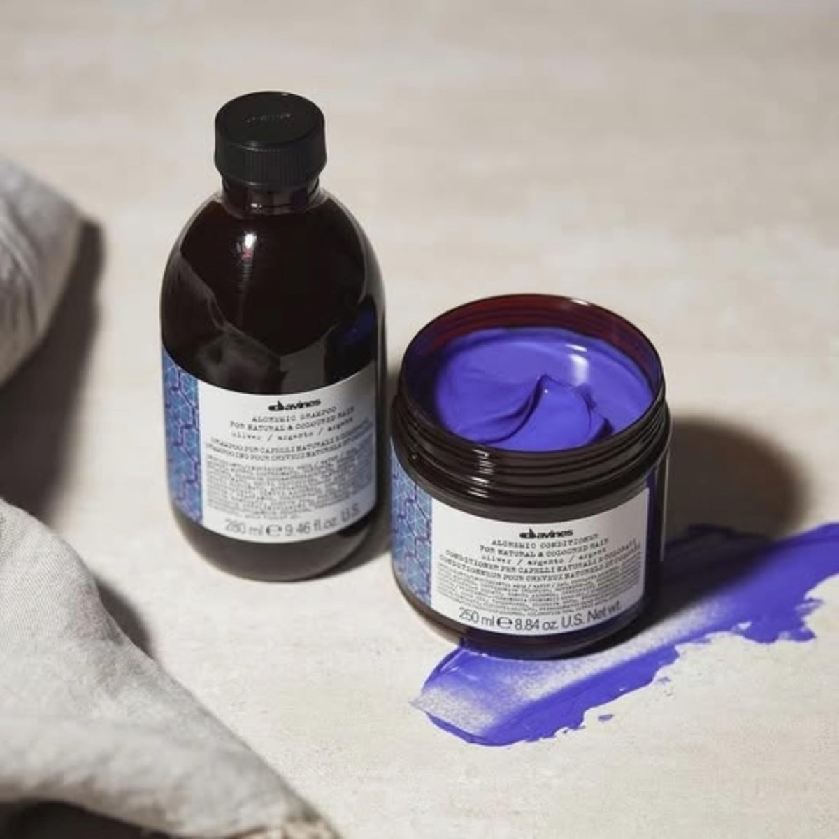 Davines Alchemic Shampoo Silver bottle next to conditioner showing routine pairing benefit