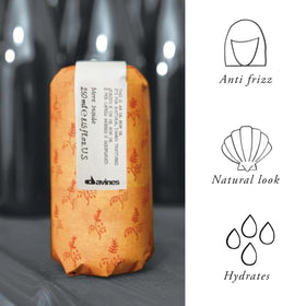 davines applying oil to damp mid-lengths for hydrated structure and natural definition