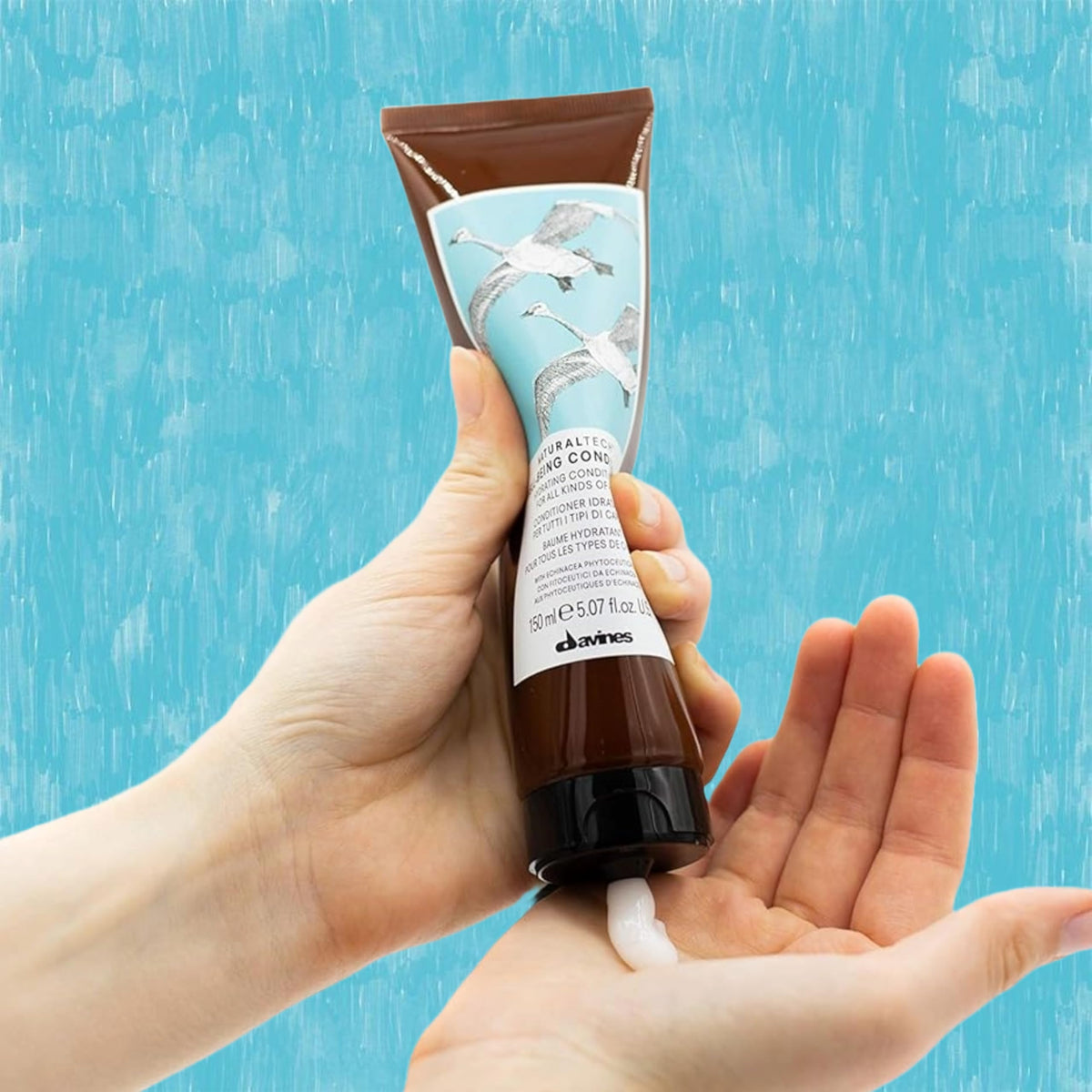 Davines conditioner applied to wet hair in shower for easier combing