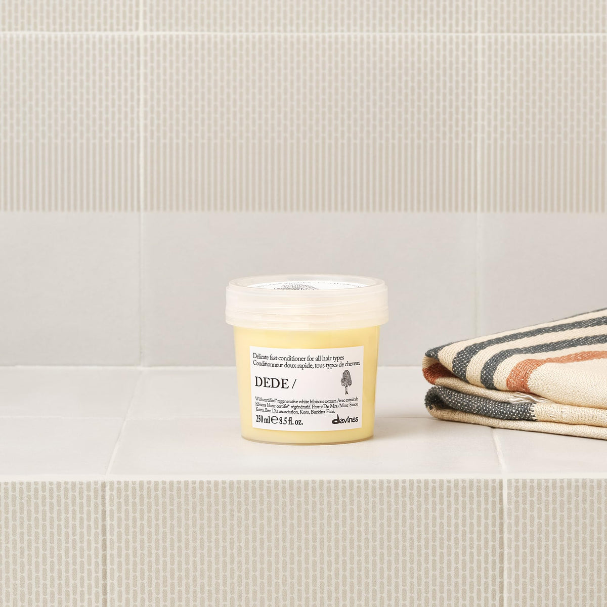 Davines DEDE conditioner cream consistency close-up showing smoothing benefit