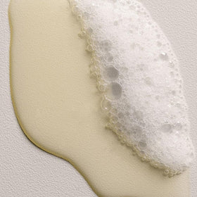 Davines DEDE shampoo being poured into hand for easy dosing