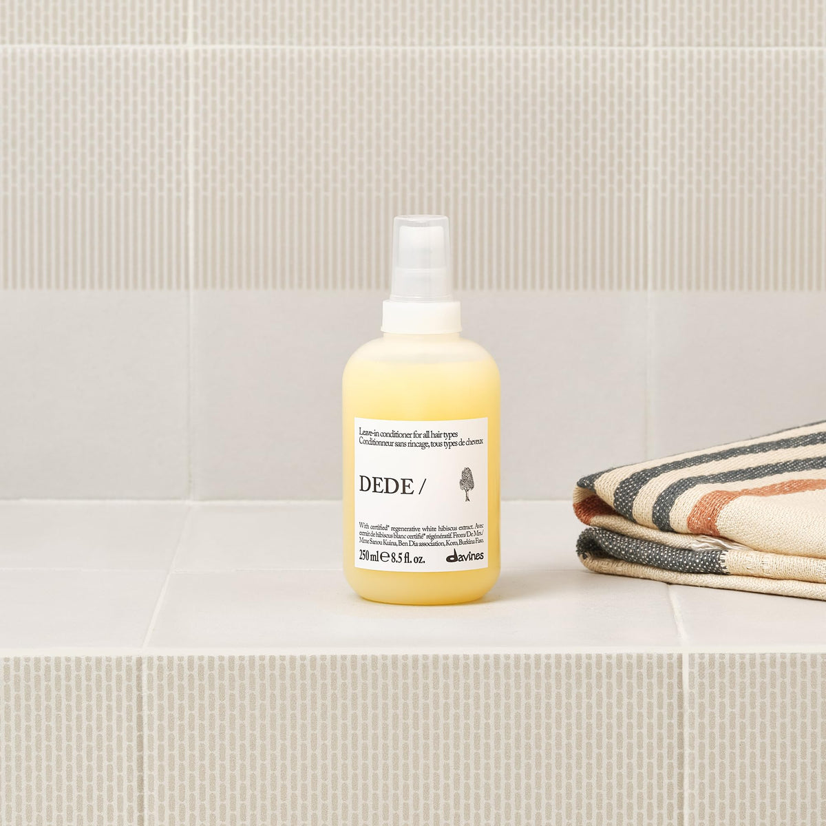 Davines DEDE being applied to hair to smooth and detangle