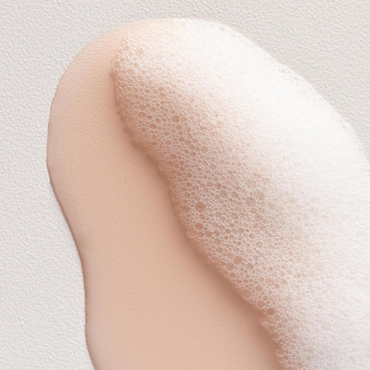 Davines bottle held in hand to show 8.45 fl oz scale and travel-friendly size