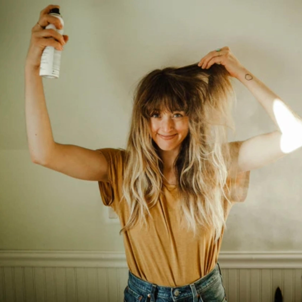 Davines bottle in hand showing 5.07 fl oz size for travel convenience