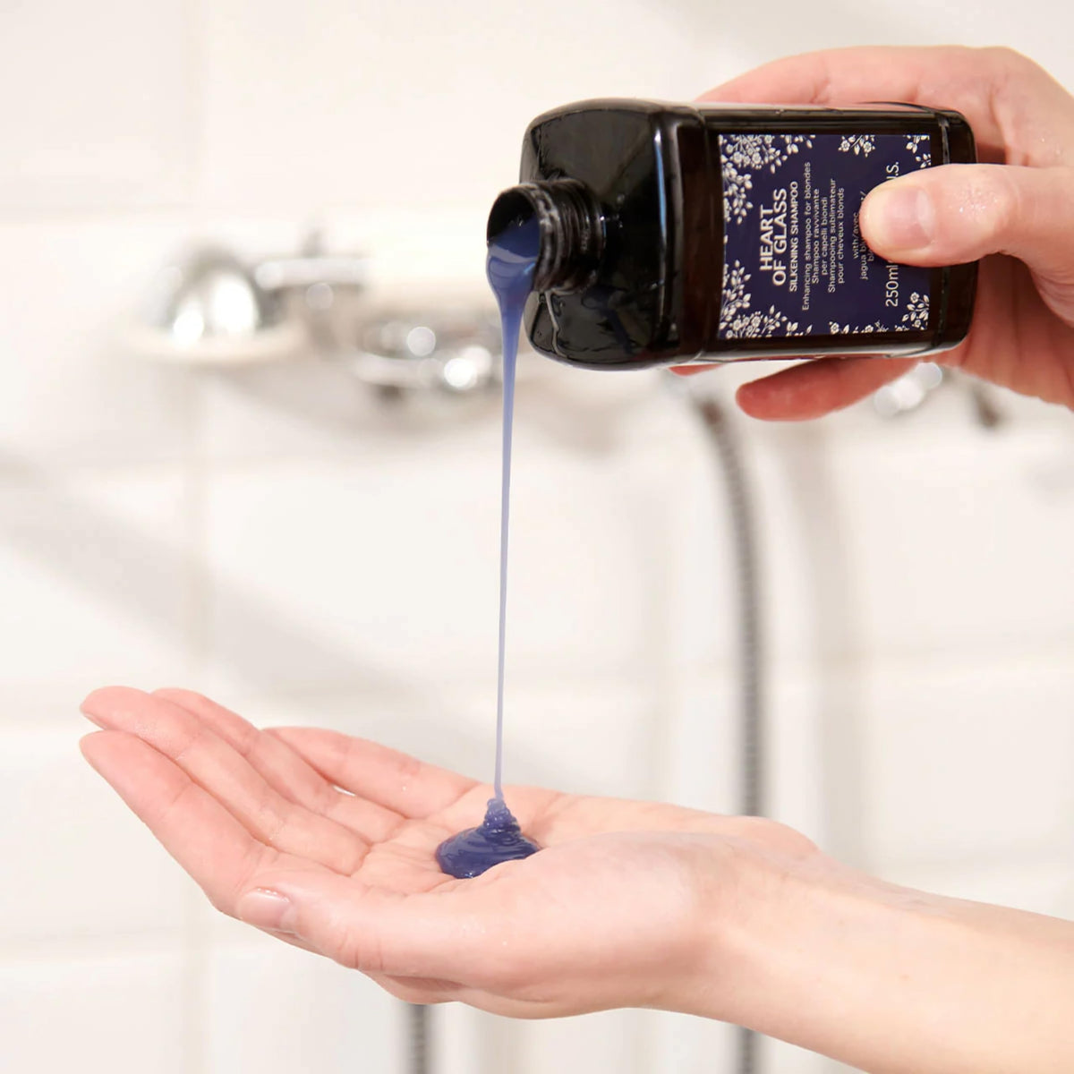 Davines Heart of Glass bottle on a travel vanity conveying portability and maintenance