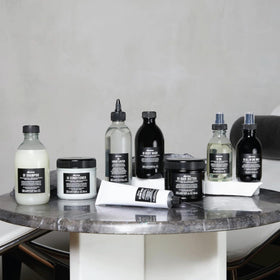 Davines jar held in hand to show size and easy-to-use portioning benefit