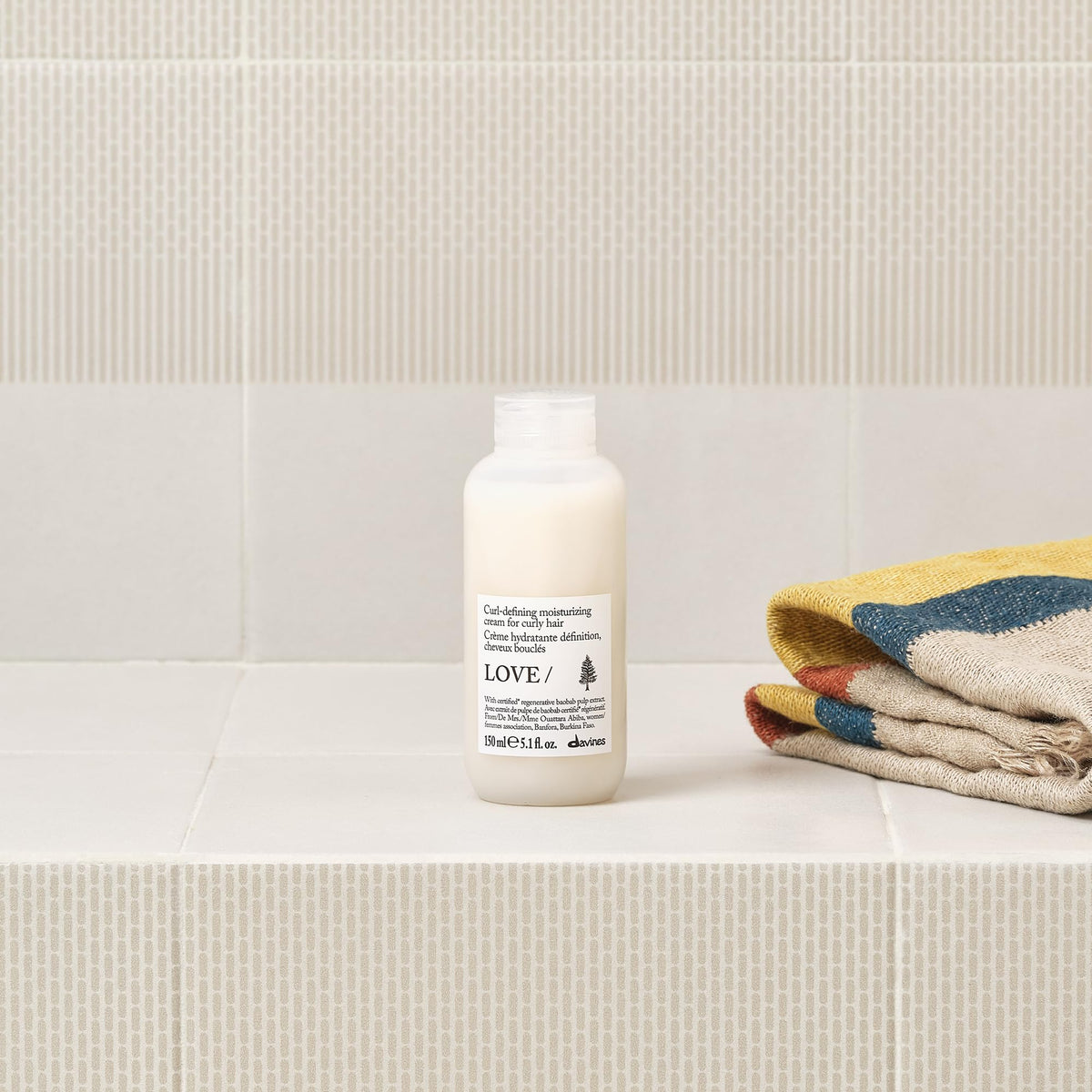 Davines product applied to damp curls showing improved definition and reduced frizz