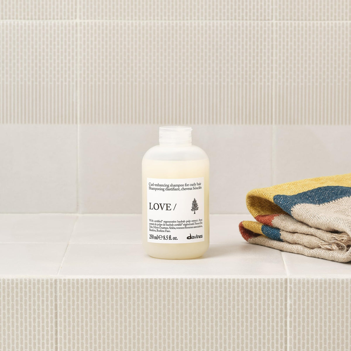 Davines product staged on shelf with styling props for routine inspiration
