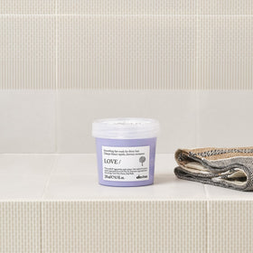 Davines jar in hand to show 8.5 oz scale for accurate size expectation