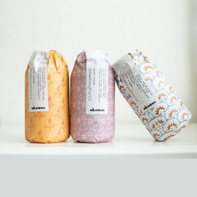 Davines medium hold gel bottle in hand showing travel-friendly size