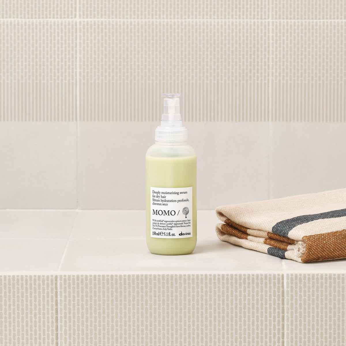Davines MOMO dispensing pump releasing serum for controlled application and less waste