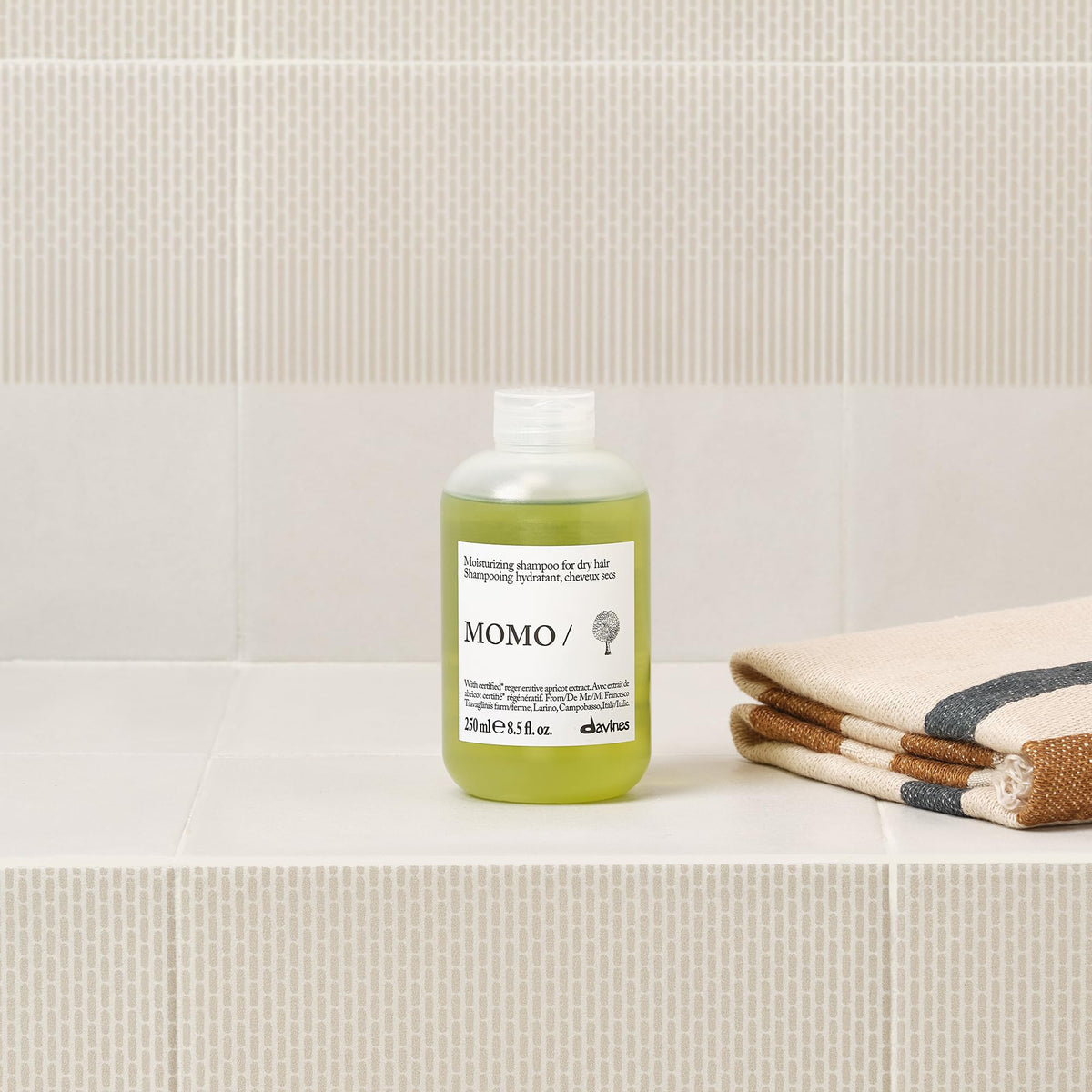 Davines MOMO shampoo being poured into a hand showing lightweight hydration benefit