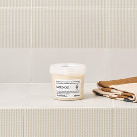 Davines NOUNOU being applied in hand to show easy spread and nourishment
