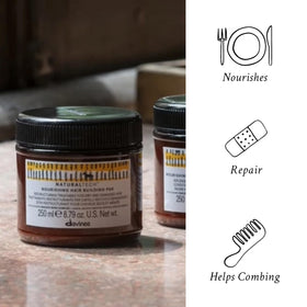 Davines mask being applied to damp hair to rebuild and hydrate strands