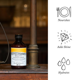 Davines rich foam on hand demonstrating gentle cleanse and detangling benefit