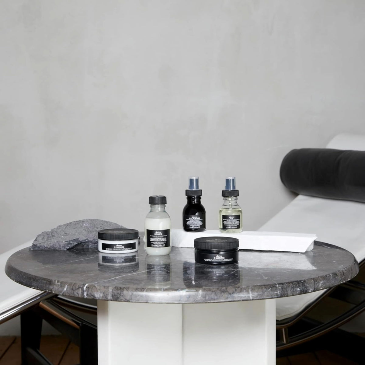 davines travel-size next to passport illustrating convenient portability
