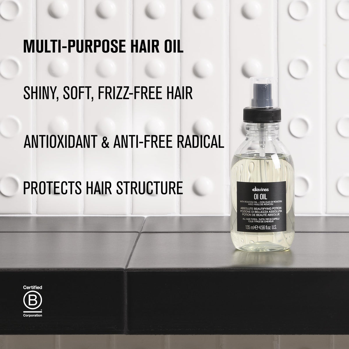 Davines OI Oil size comparison next to hand illustrating 4.56 fl oz scale