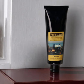 Davines jar in hand showing size and scale for travel-friendly benefit