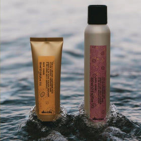 Davines bottle in hand to show 4.23 fl oz size and travel-friendly