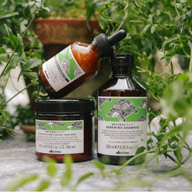 Davines bottle next to ruler showing 8.45 fl oz size and scale