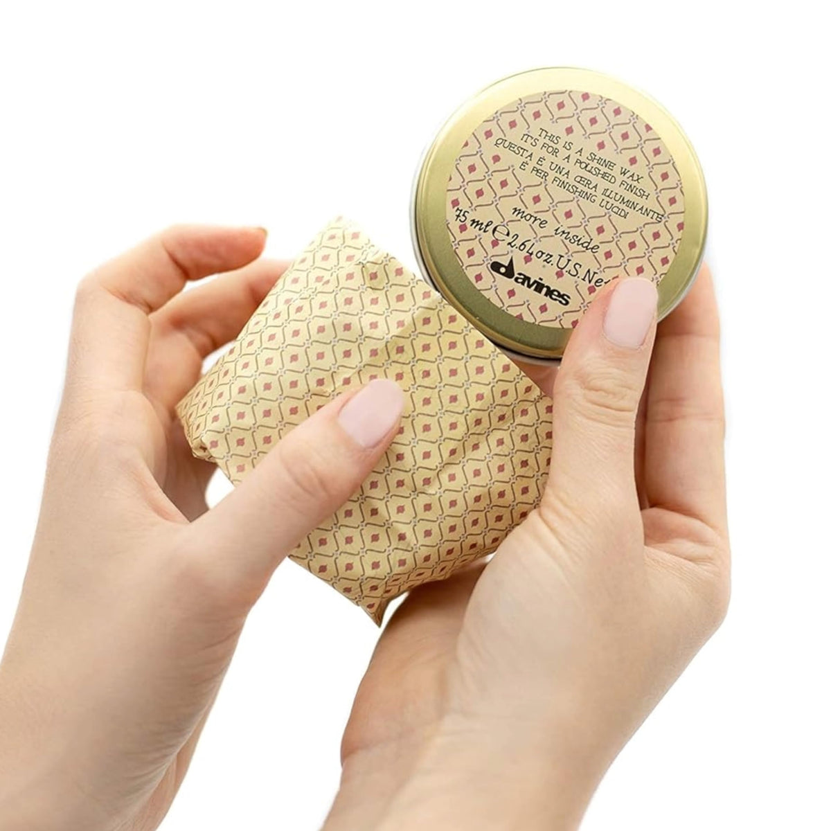 Davines shine wax rubbed on hands demonstrating workable texture benefit