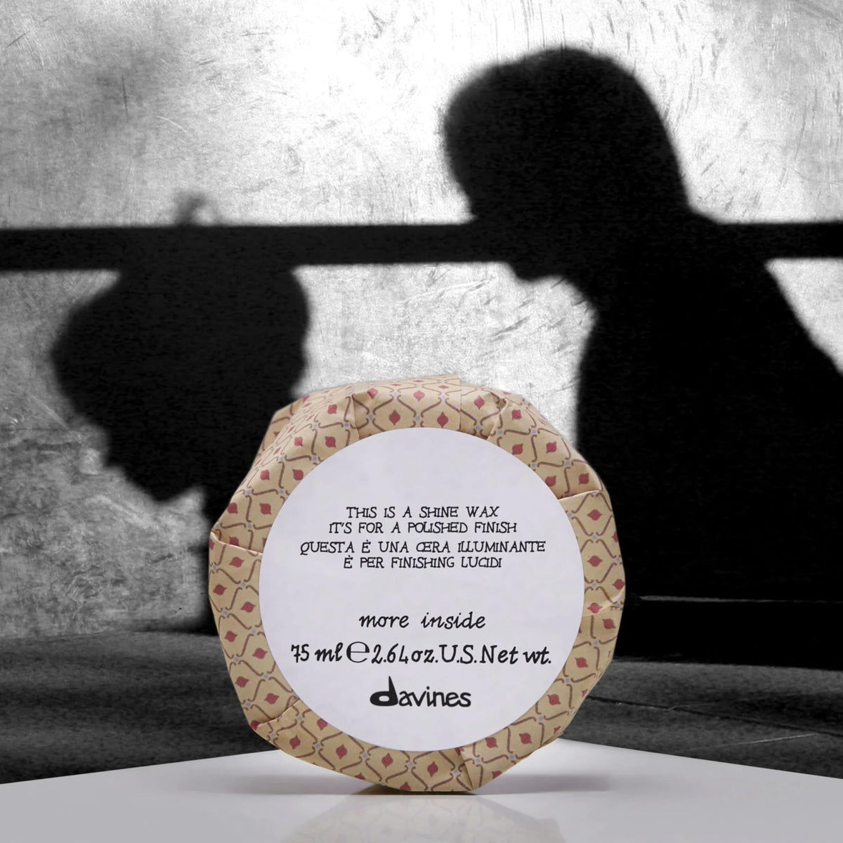 Davines shine wax polishing an updo highlighting smooth, controlled look benefit