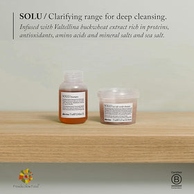 Davines travel-size tube sitting on towel for convenient portability