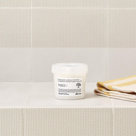 Davines VOLU/ bottle label detail, emphasizes ingredient transparency and brand benefit