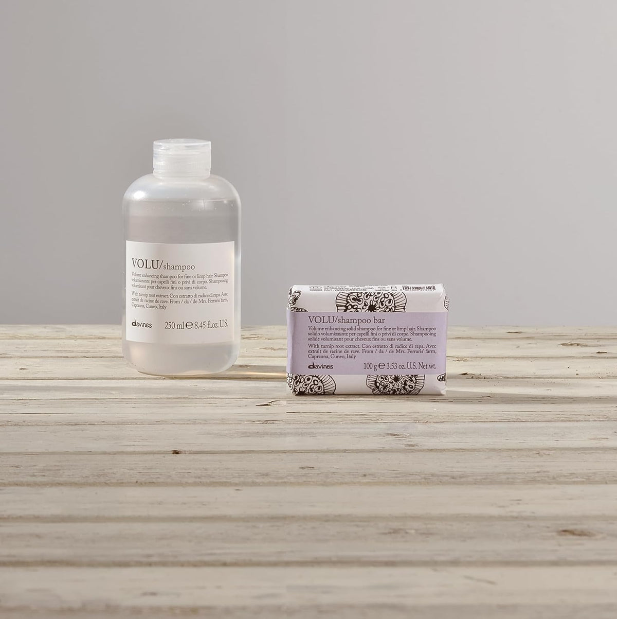 Davines VOLU shampoo bar styled in bathroom setting conveying premium sustainable routine