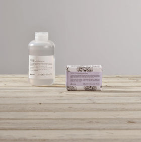 Davines VOLU shampoo bar styled in bathroom setting conveying premium sustainable routine