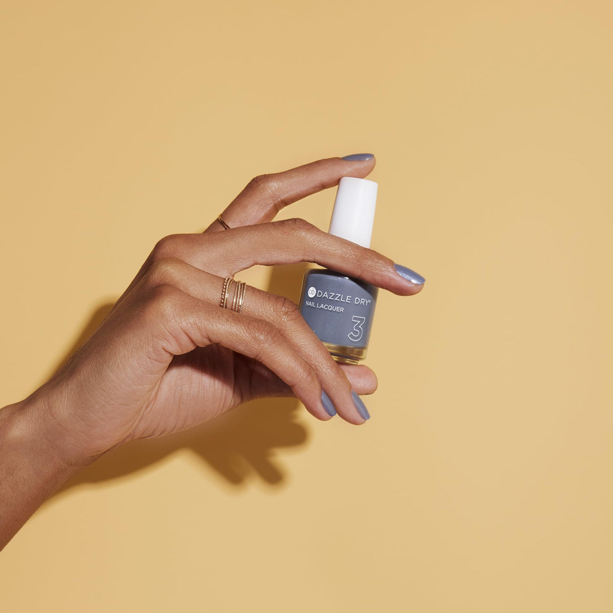 Dazzle Dry Blue Moon applied on model nails demonstrating salon-quality wear and shine