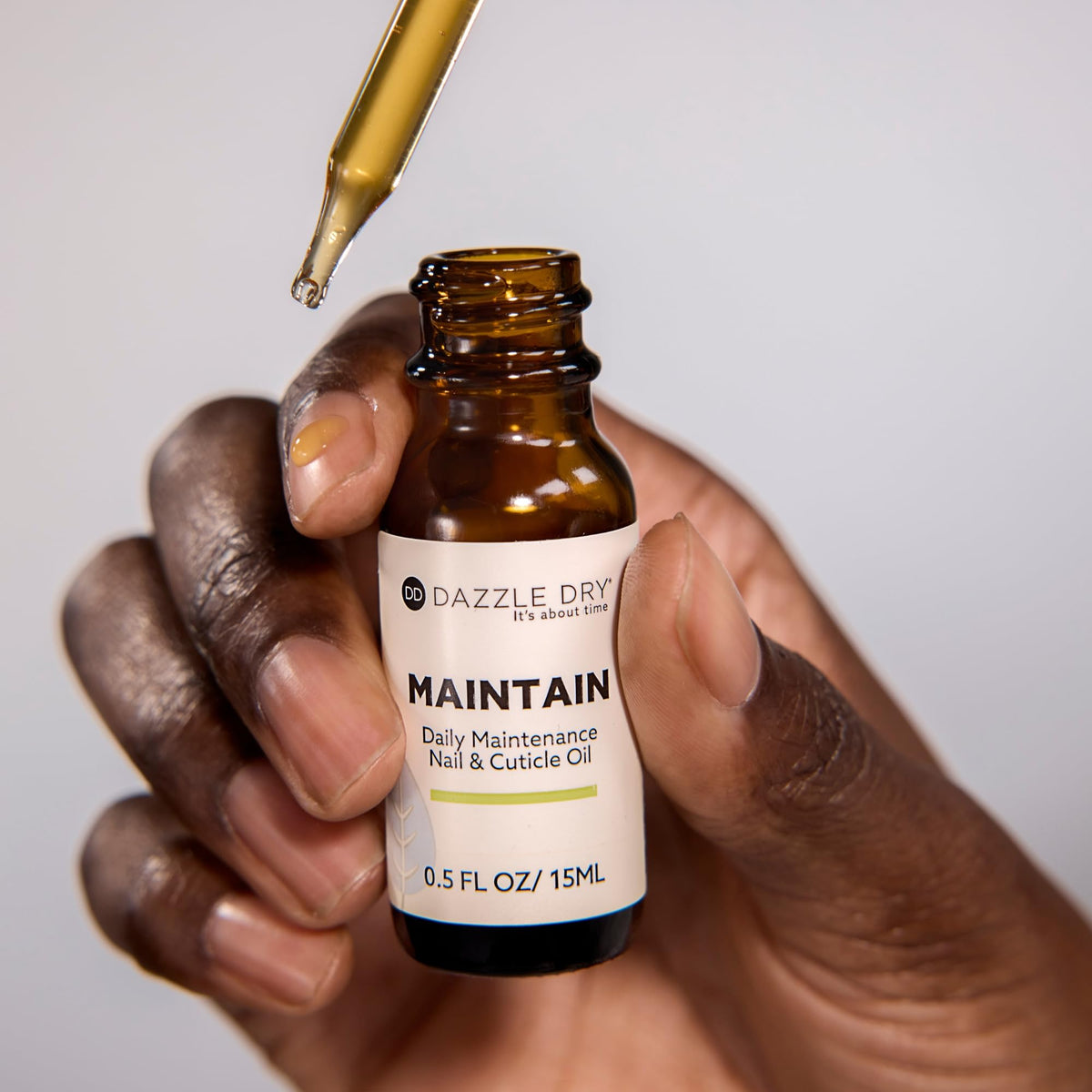 Dazzle Dry dropper applicator dispensing oil for precise, no-waste application