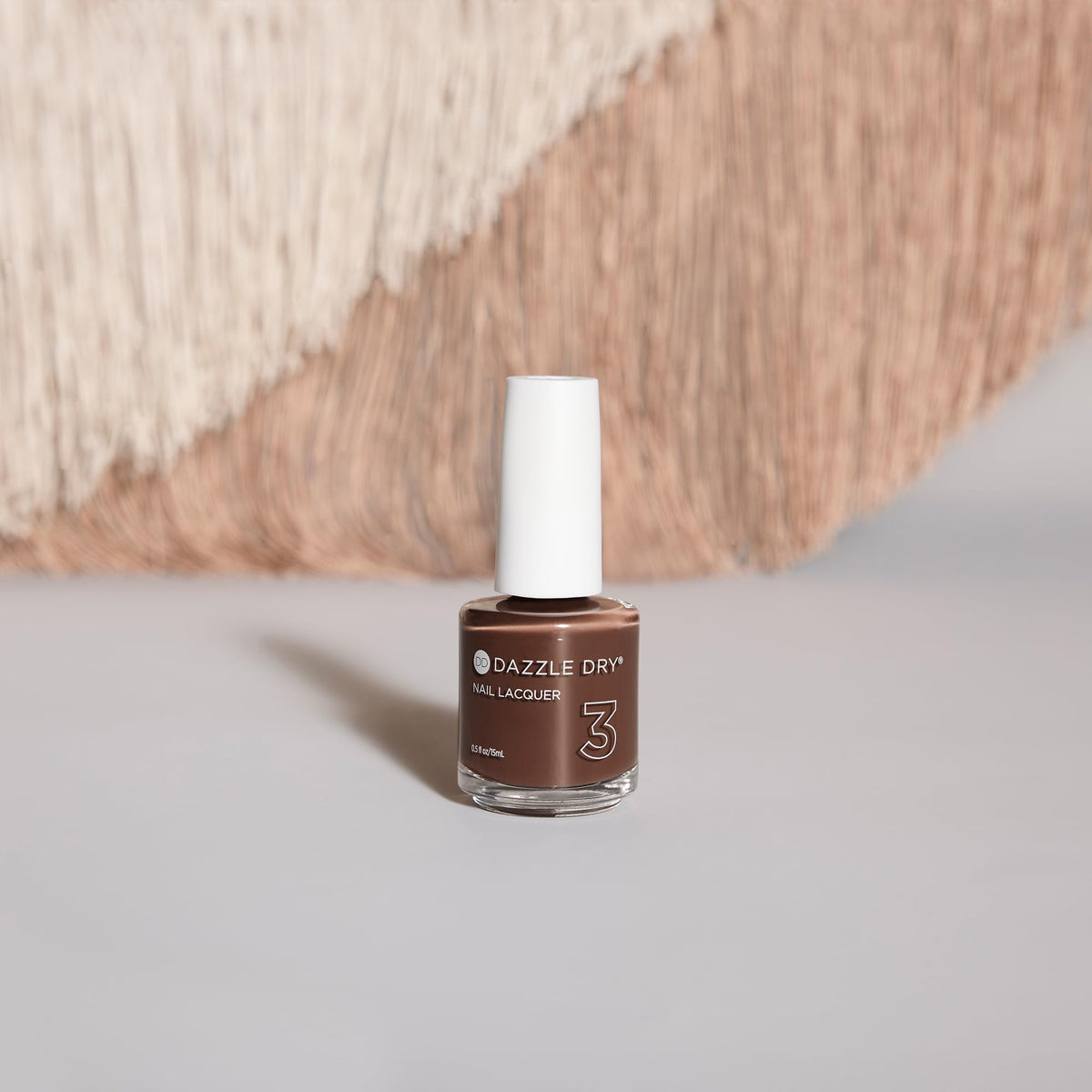 Dazzle Dry 0.5 fl oz bottle beside a coin for Fringe scale reference