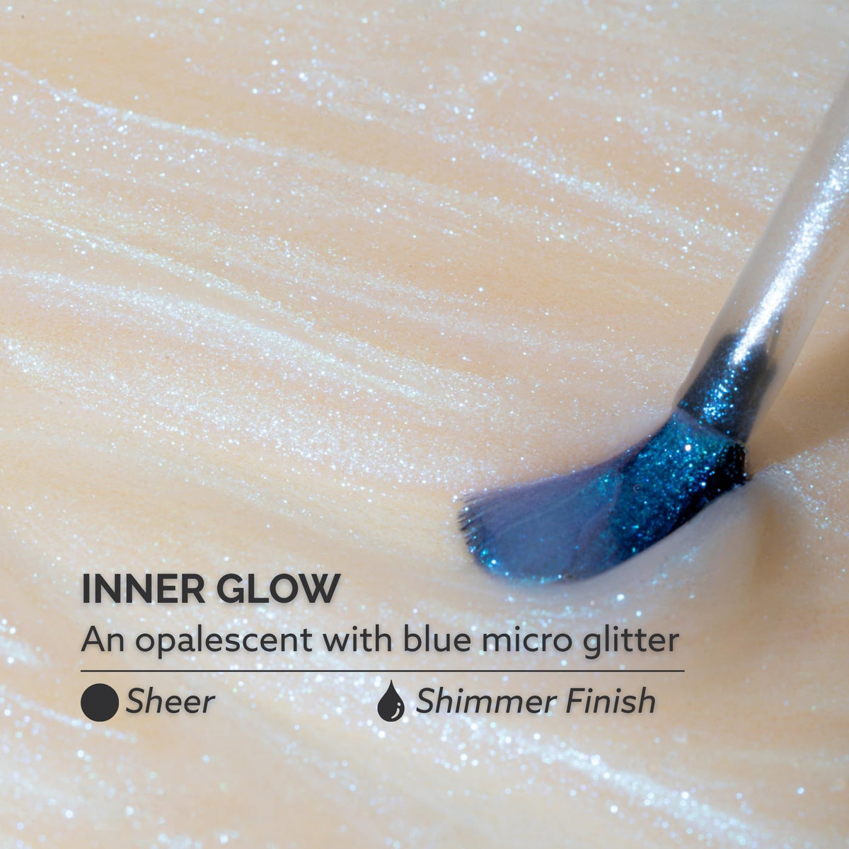 Close-up of Inner Glow blue micro-glitter showing Dazzle Dry luminous sparkle benefit
