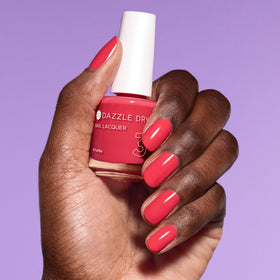 Dazzle Dry size comparison with hand to show 0.5 fl oz scale and portability