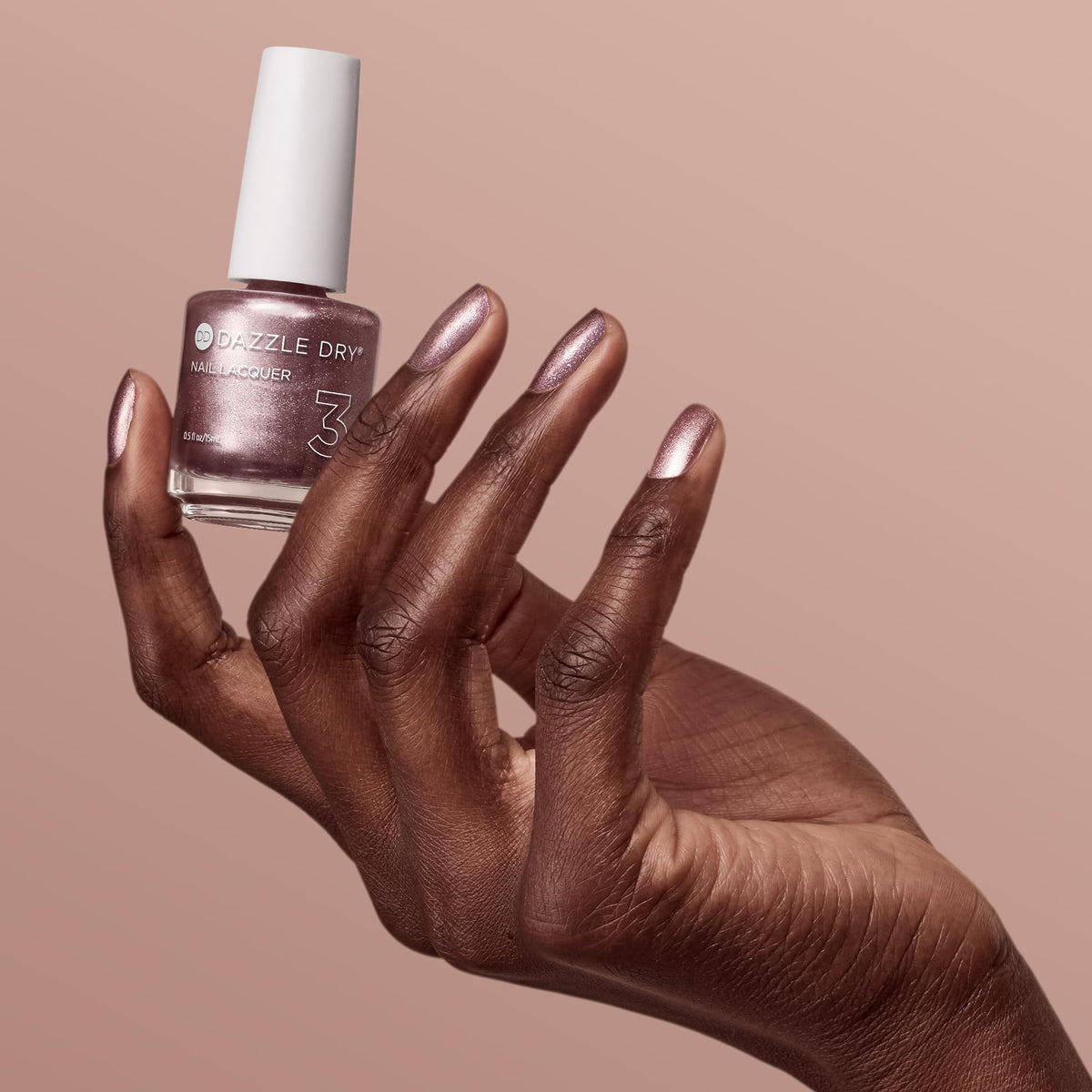 Dazzle Dry manicure on hand demonstrating salon-quality rose gold shine